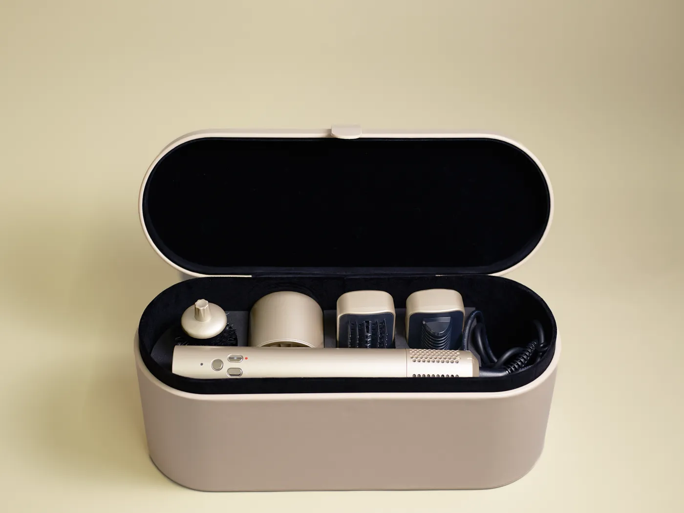 The Shiny Curls handle and attachments packed inside the open storage case