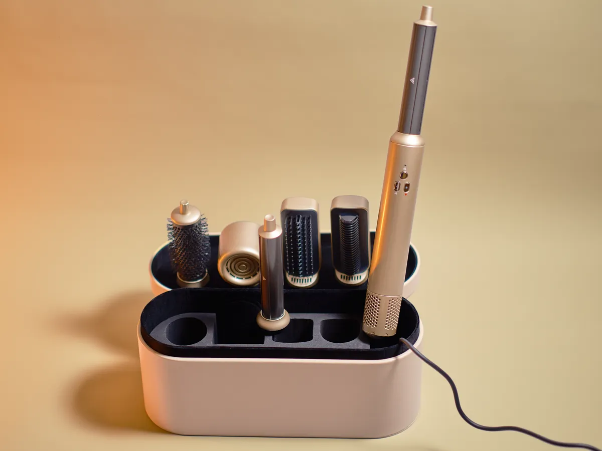 The styling handle and attachments standing upright in the open storage case